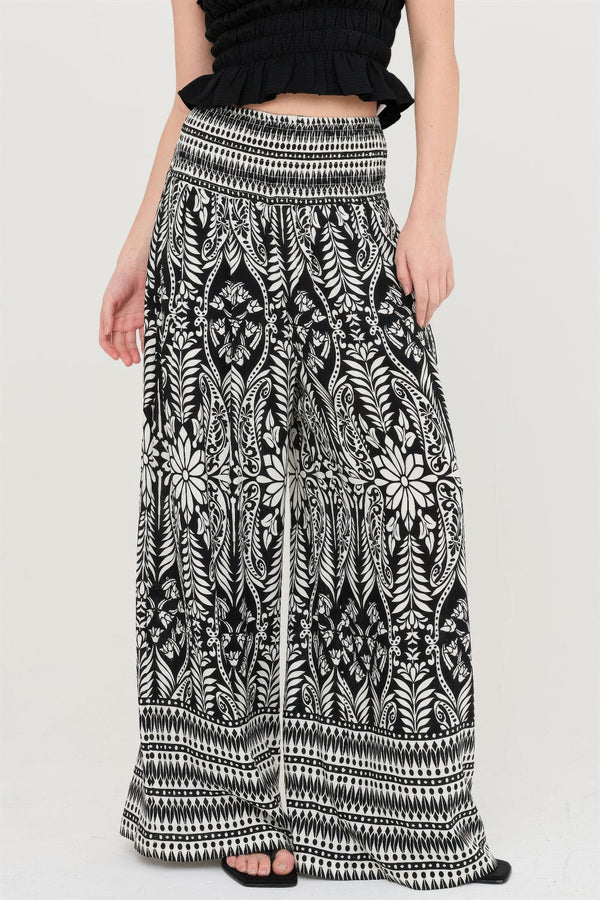Black and white floral print wide-leg palazzo pants with elastic waist, styled with ruffle top