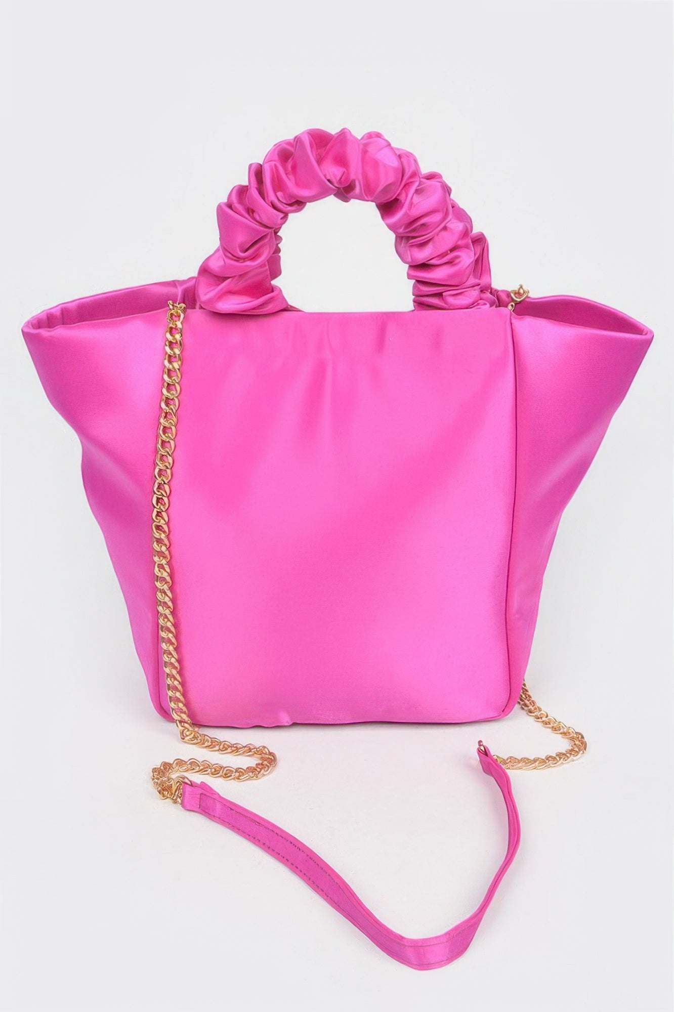Vibrant pink satin tote bag with ruched top handle and gold chain strap, perfect for chic everyday style.