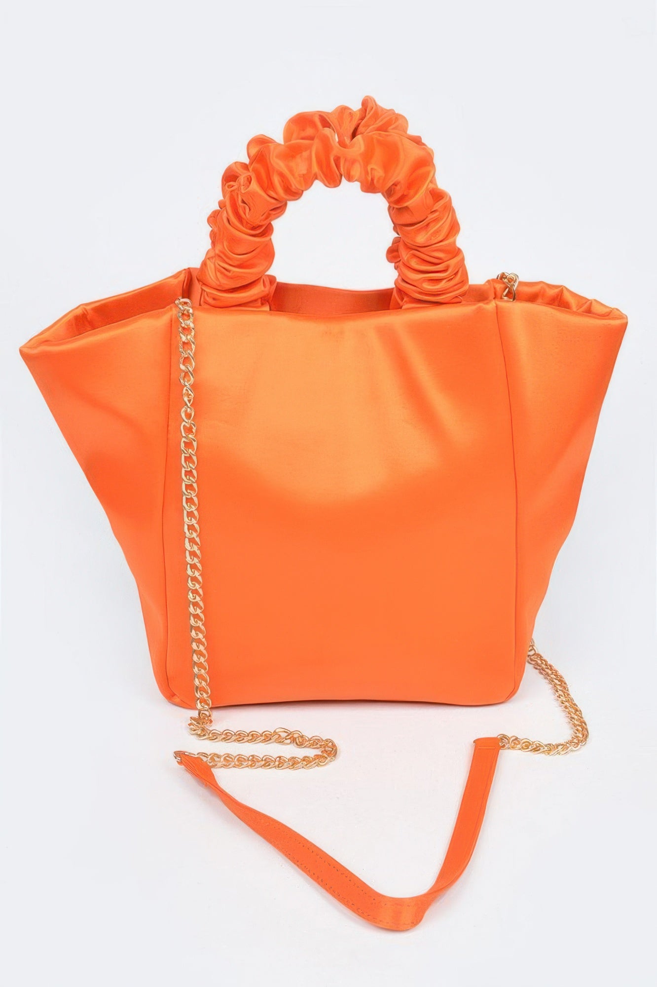 Vibrant orange satin tote bag with ruched handles and gold chain strap, perfect for chic everyday style.