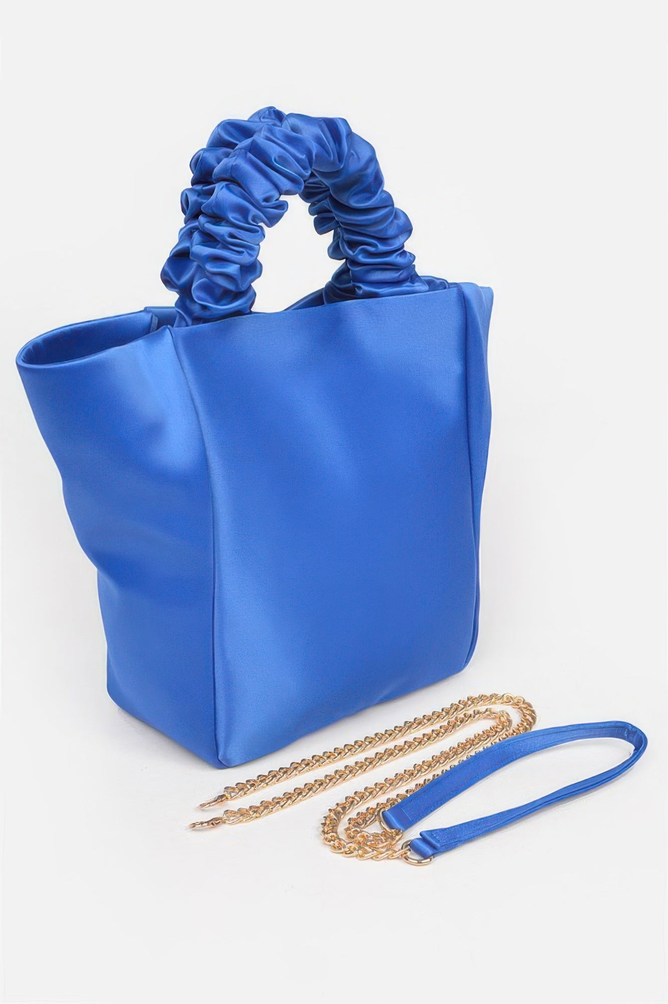 Royal blue satin tote bag with ruched handles and gold chain strap, chic women's fashion accessory