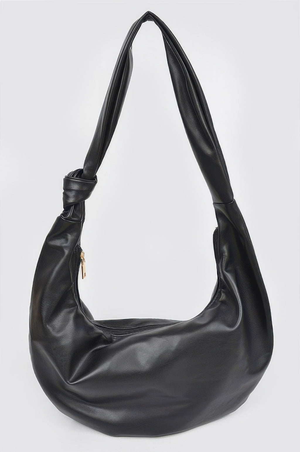 Black leather hobo bag with knotted strap and gold zipper, stylish women's accessory for everyday fashion