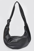 Black leather hobo bag with knotted strap and gold zipper, stylish women's accessory for everyday fashion