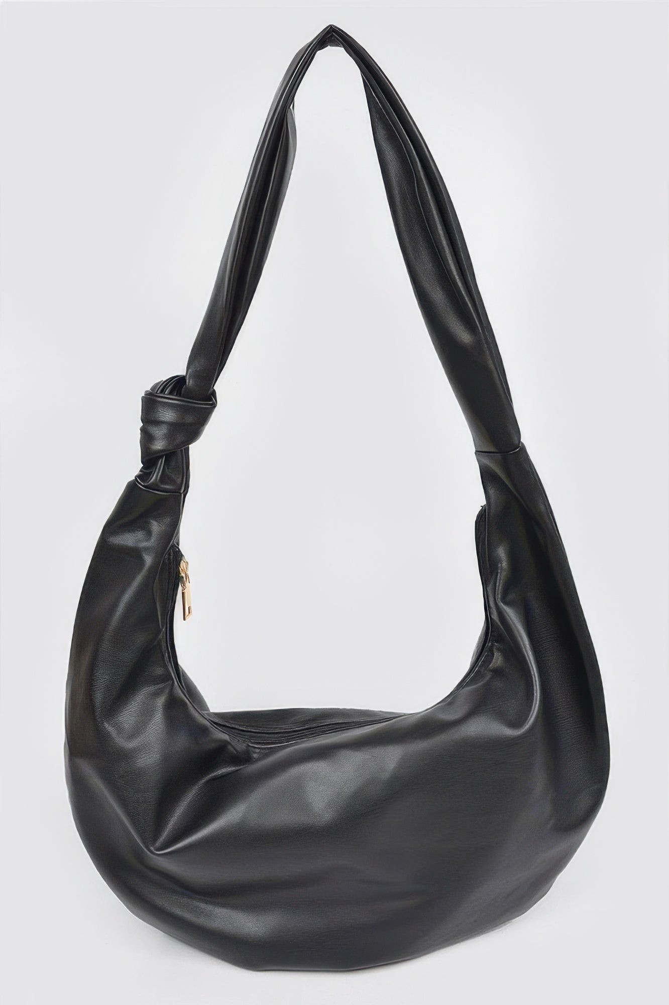 Black leather hobo bag with knotted strap and gold zipper, stylish women's accessory for everyday fashion