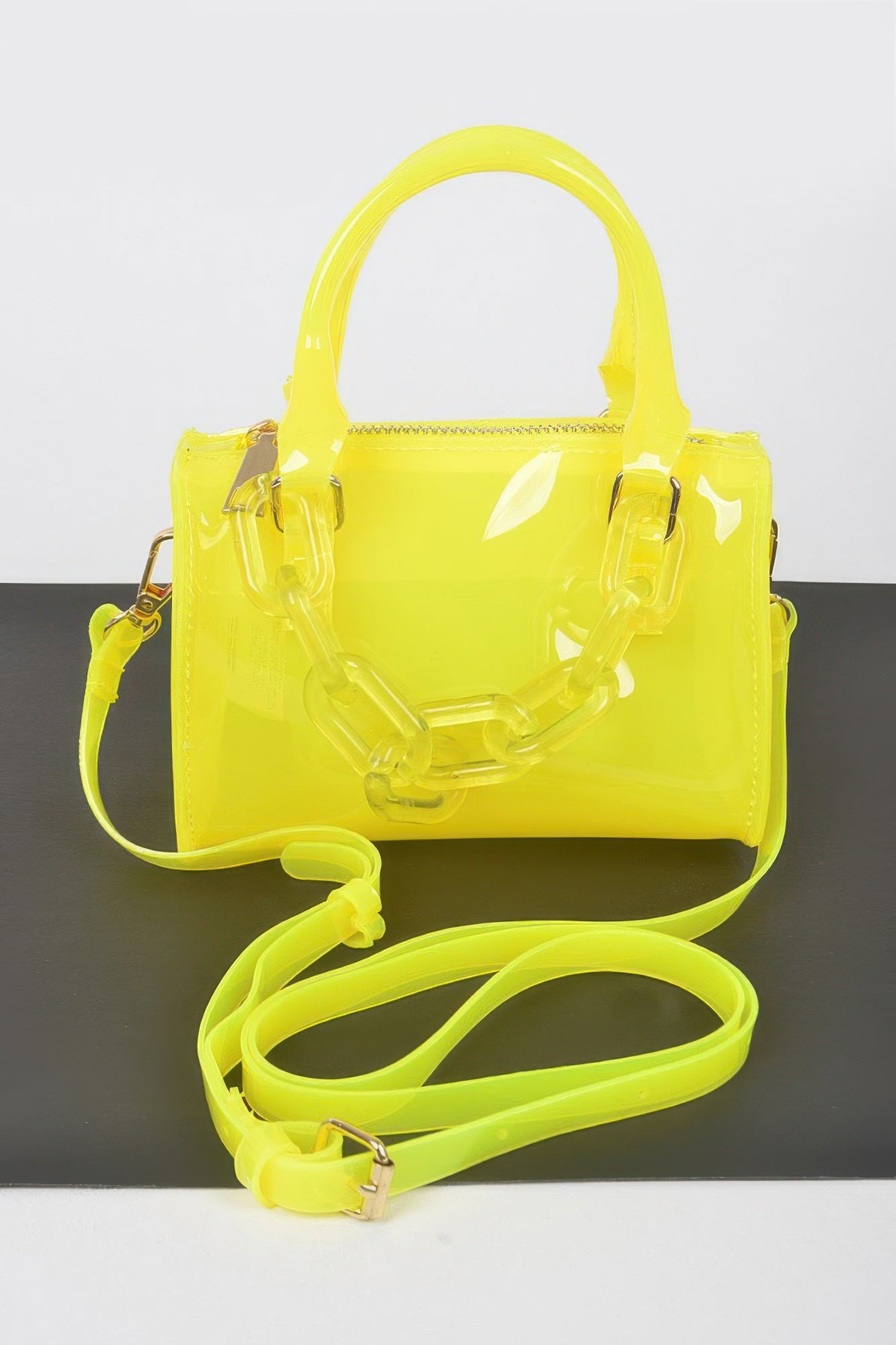 Neon yellow transparent handbag with chunky chain strap and top handle, stylish women's fashion accessory