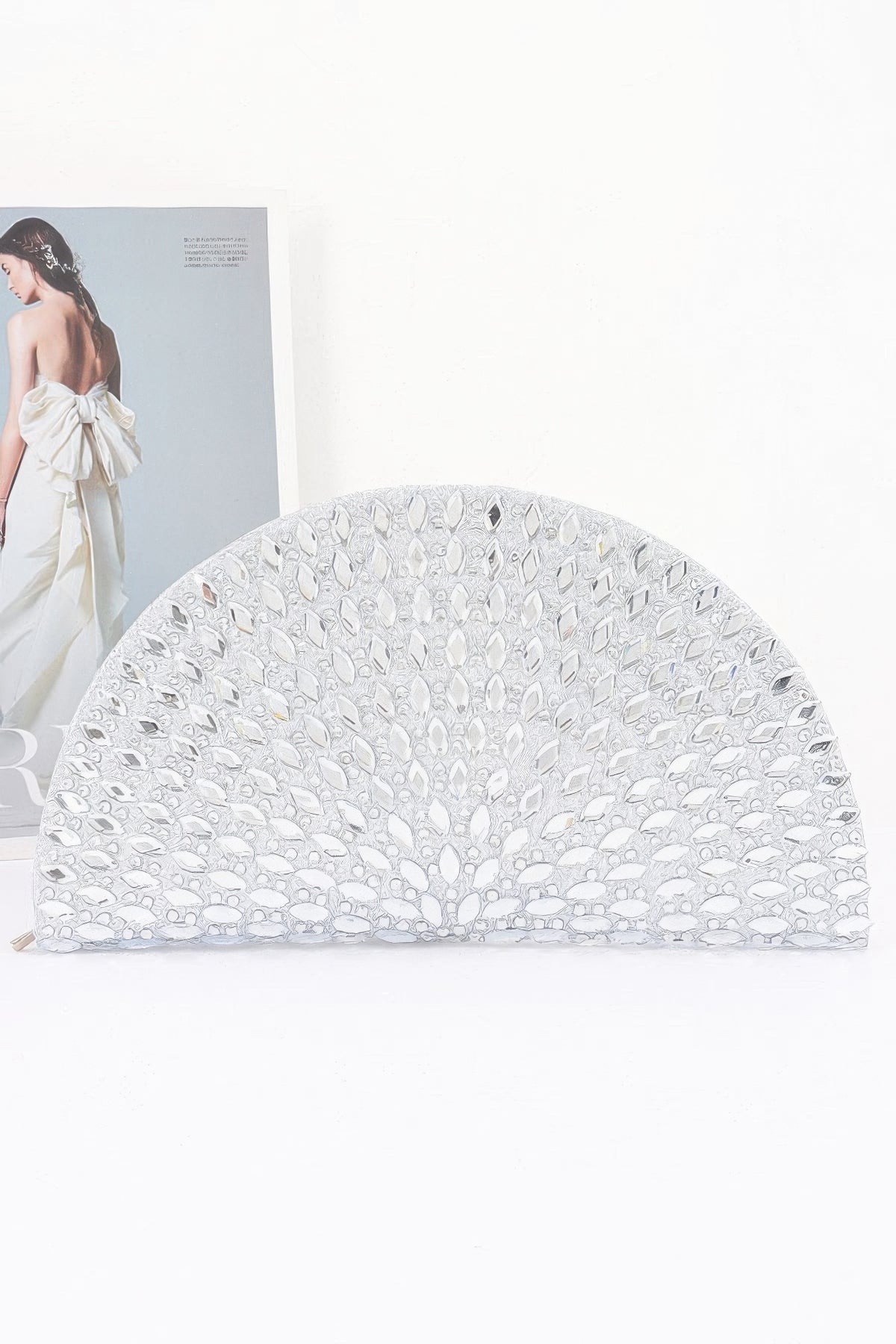 Elegant white half-moon clutch with crystal embellishments, perfect for evening wear and special occasions.