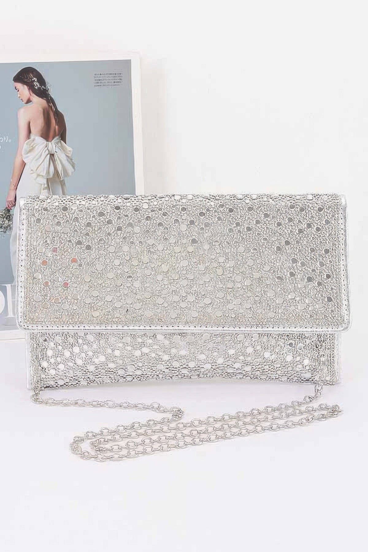 Sparkly silver clutch with chain strap, perfect for evening wear and special occasions.