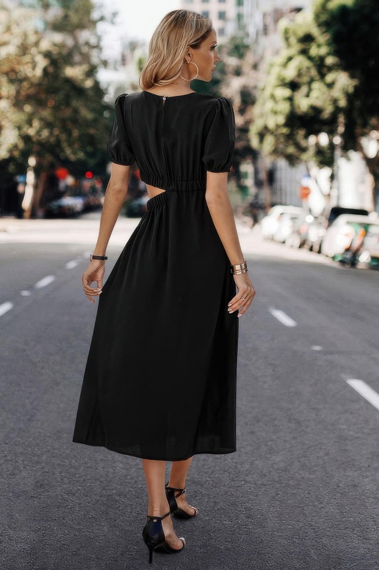 Black midi dress with puff sleeves and back cutout, styled for elegant everyday wear