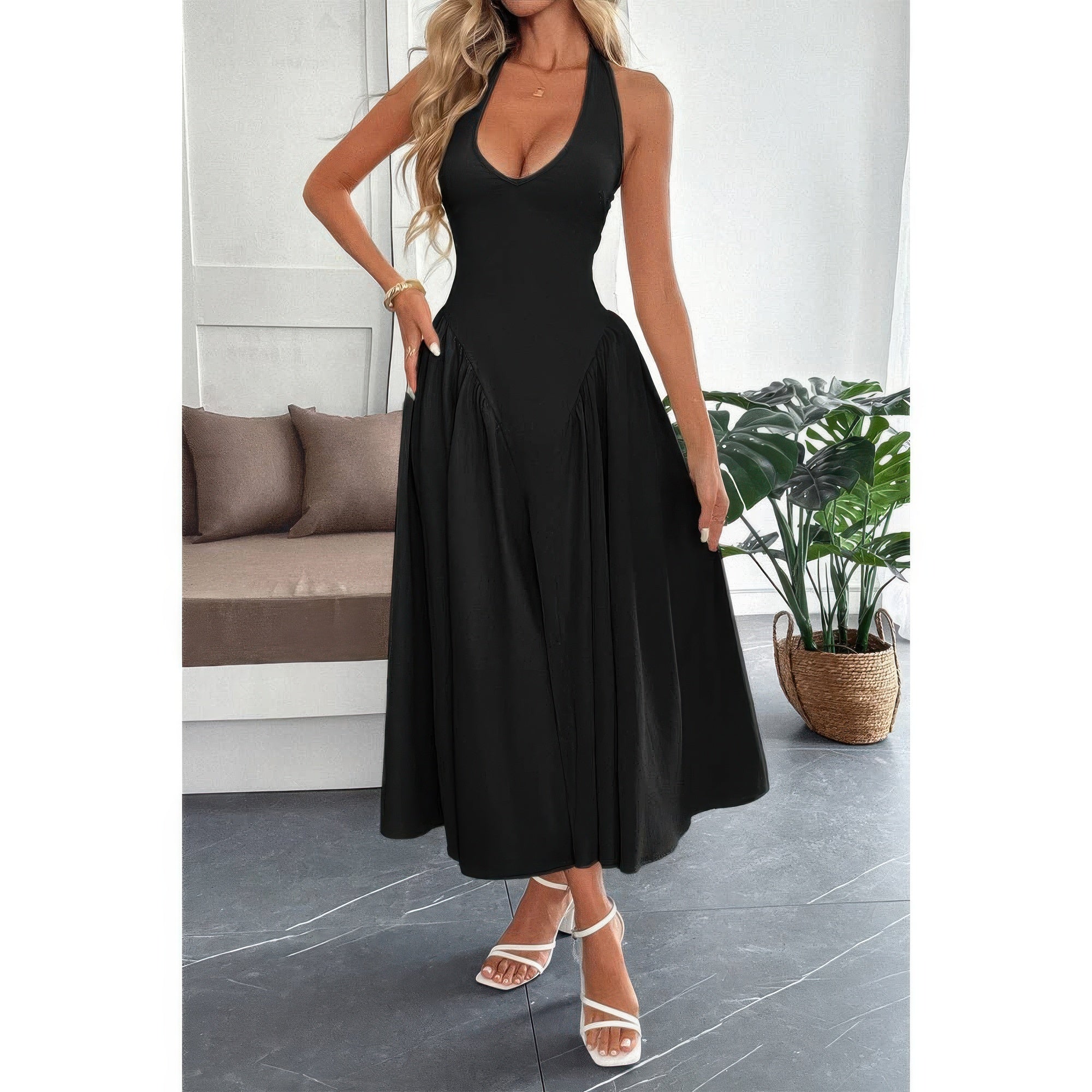 Black halter neck midi dress with flowy skirt, styled for elegant everyday wear