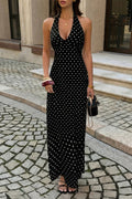 Black polka dot halter maxi dress with deep V-neck, styled with gold jewelry and sandals for elegant everyday wear